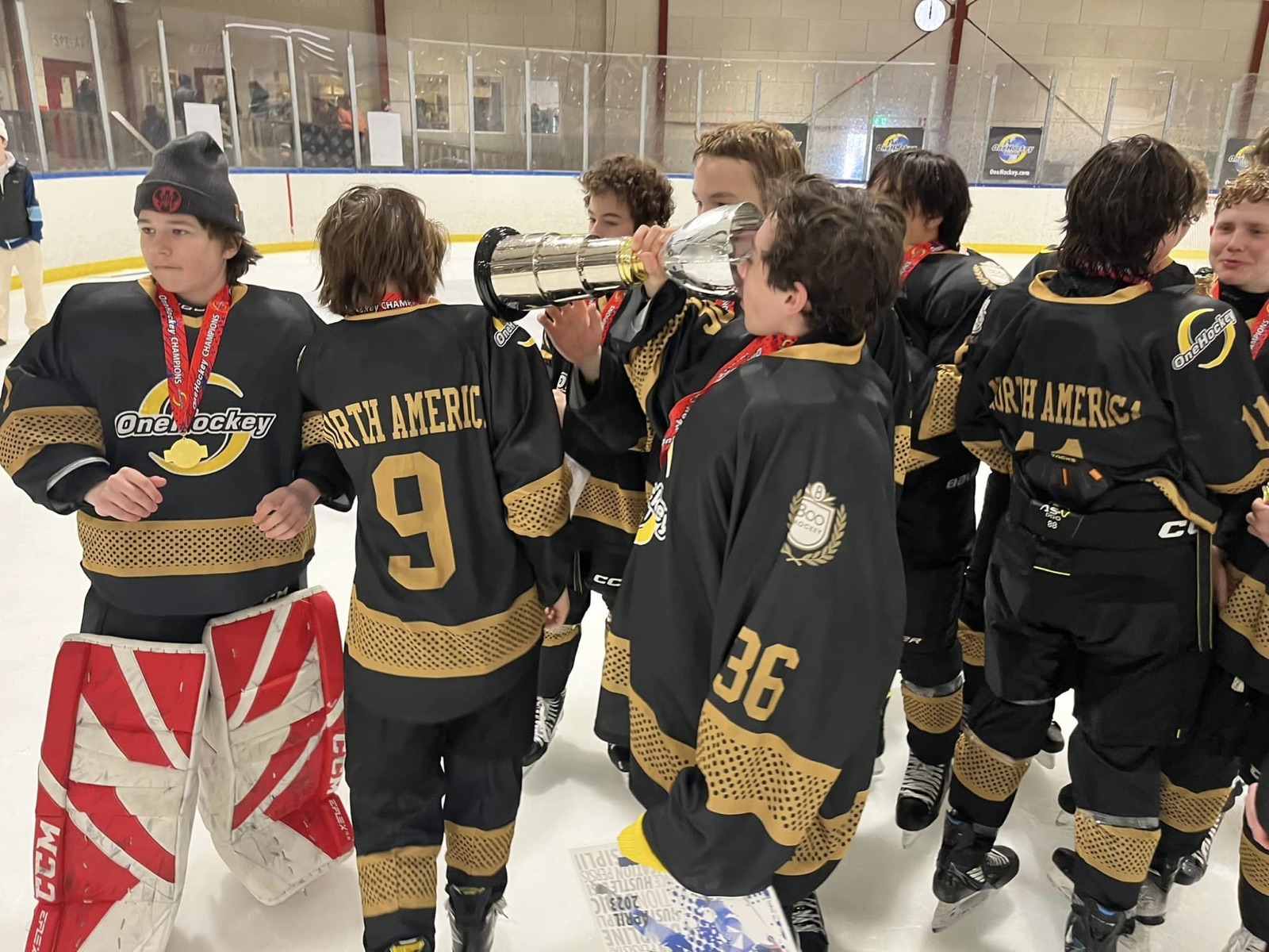 Adult team lifting the championship trophy